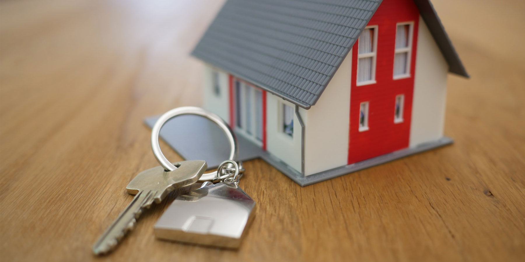 Company-Loan-Mortgage Image of a model house and a key